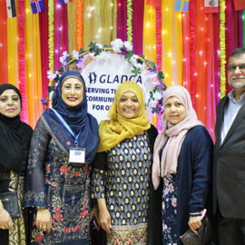 A group of lading standing in front og GLADCA Seving The Community For 50 Years